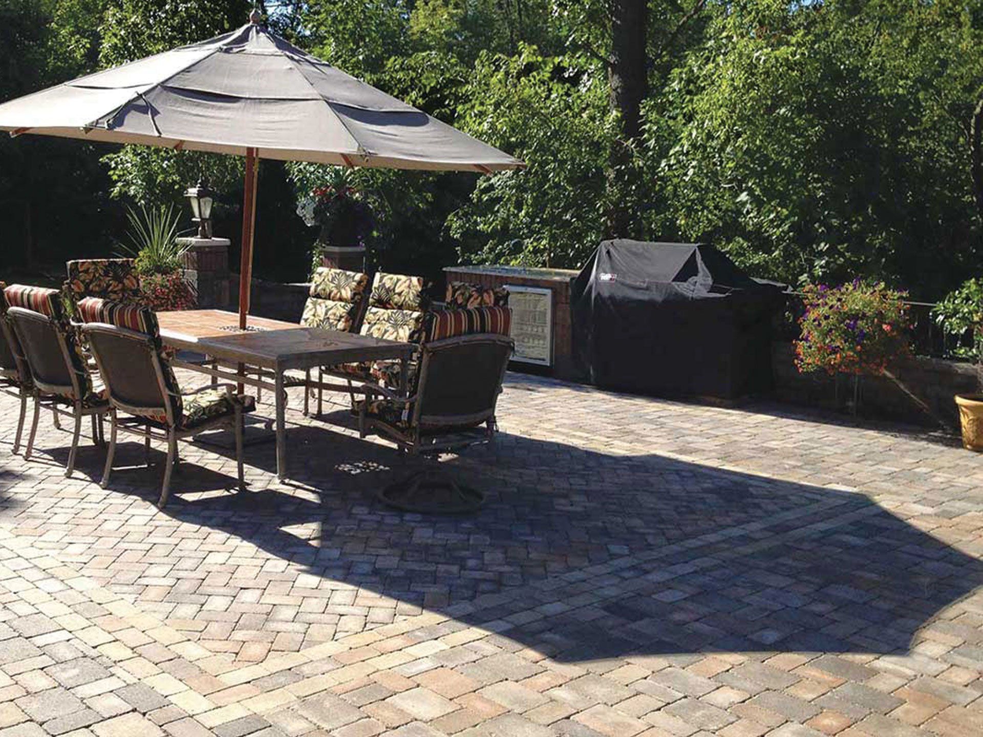a patio with a table and chairs under an umbrella