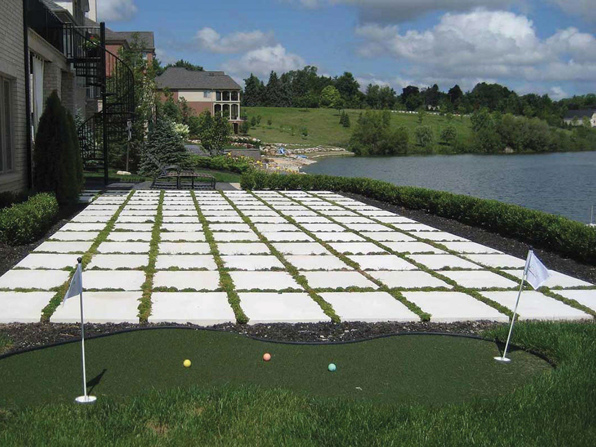 a putting green with a lake in the background