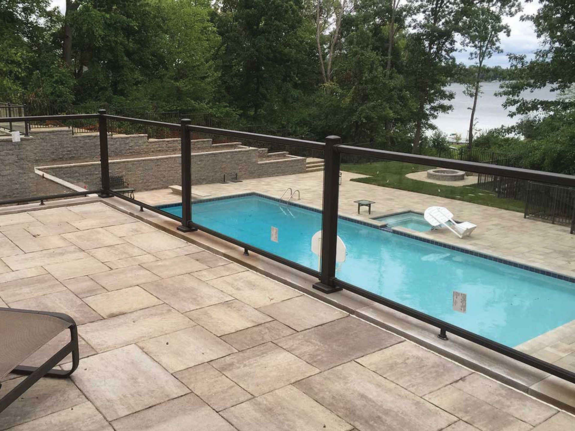 a large swimming pool is surrounded by a glass railing