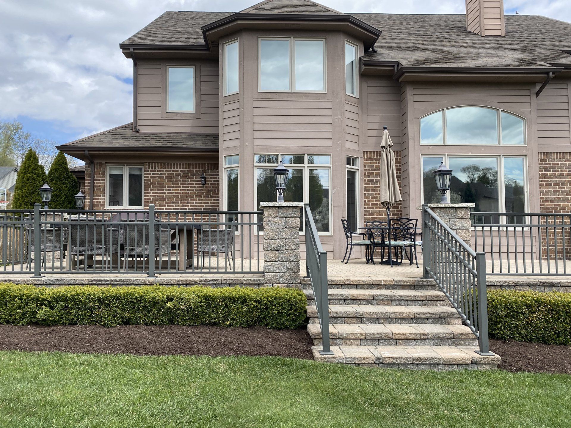 a large house with a patio and stairs leading to it .