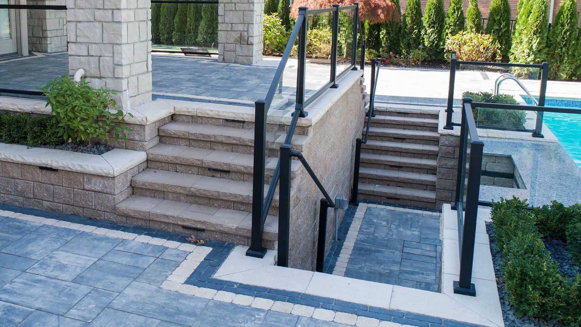 A set of stairs leading up to a pool with a railing.