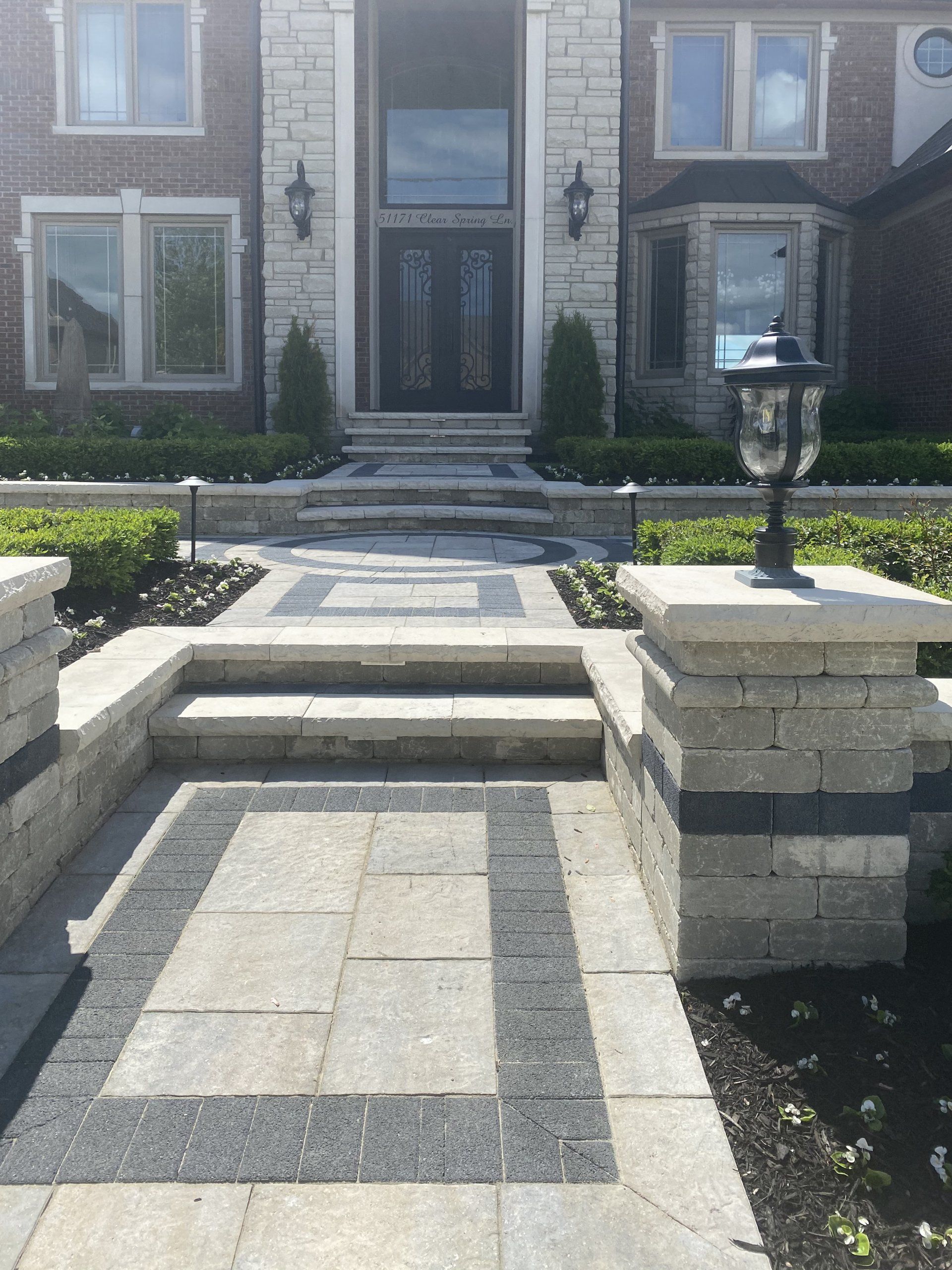 a brick walkway leading to the front door of a house