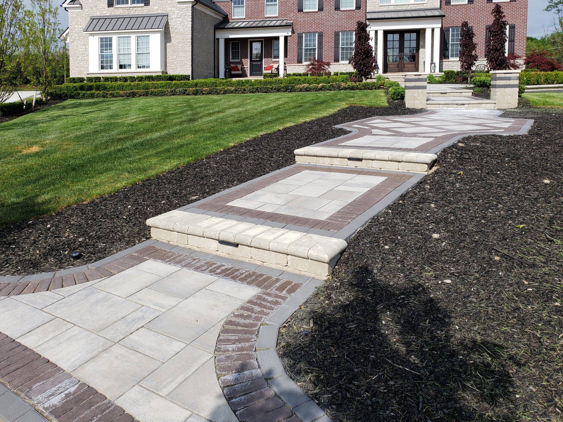 a brick house with a walkway leading to it