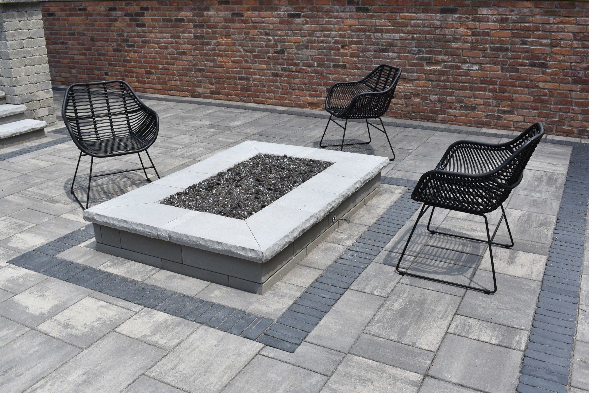 There is a fire pit in the middle of the patio.