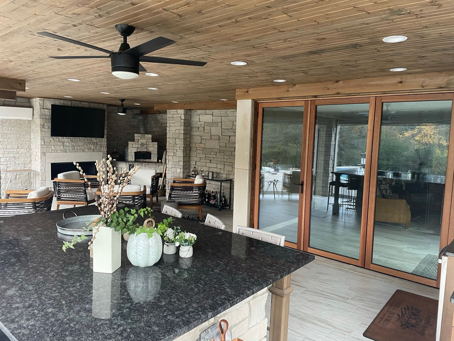 A kitchen with a ceiling fan and sliding glass doors.