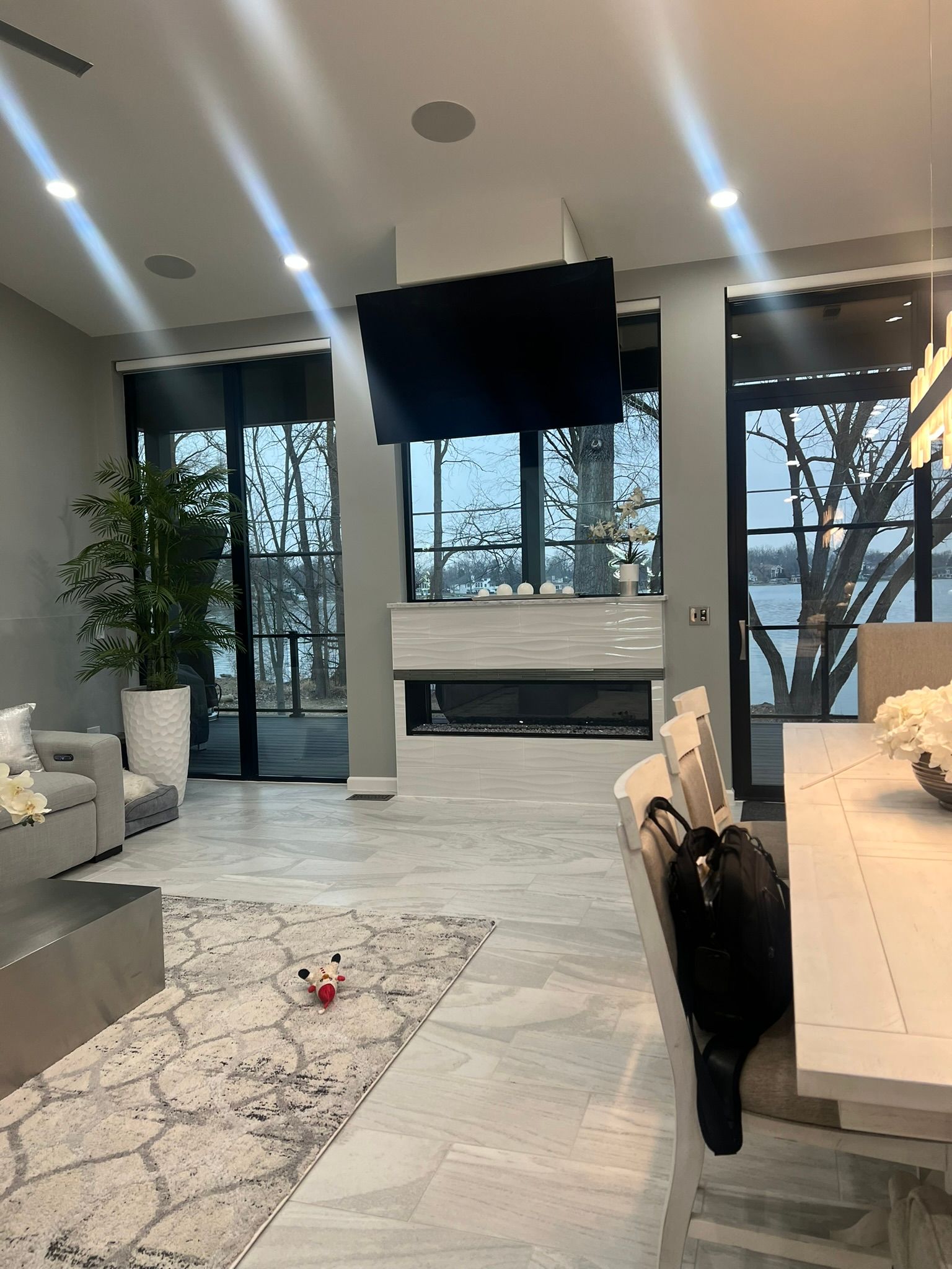 A living room with a couch , table , chairs and a fireplace.