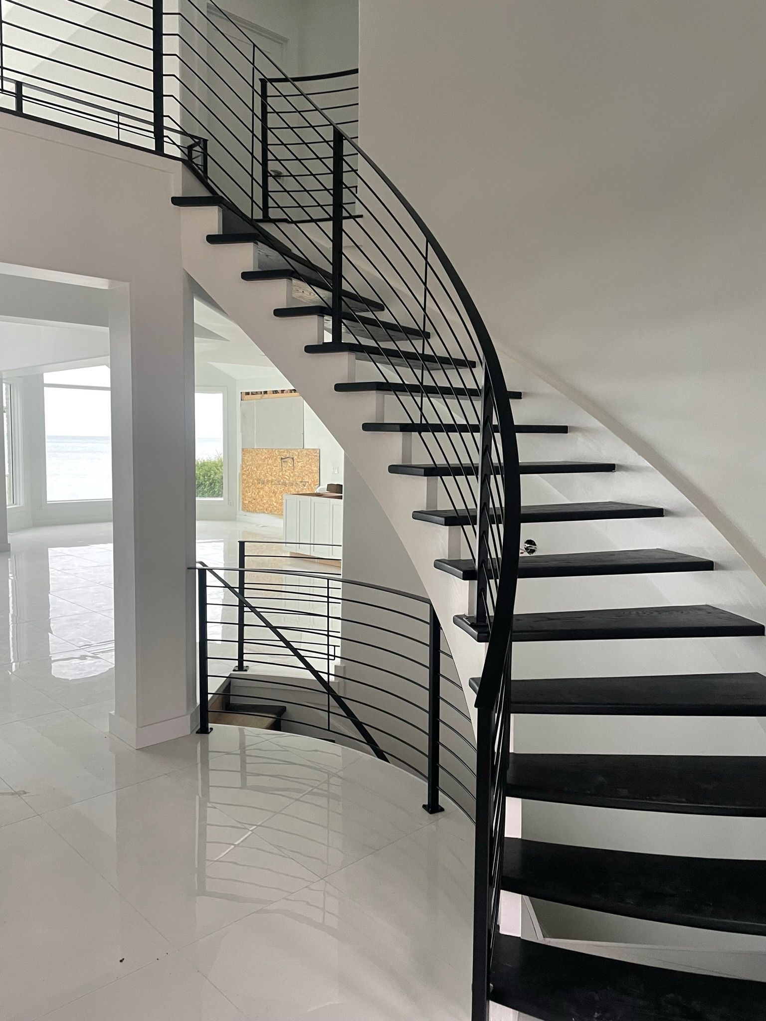 A black and white spiral staircase with a metal railing