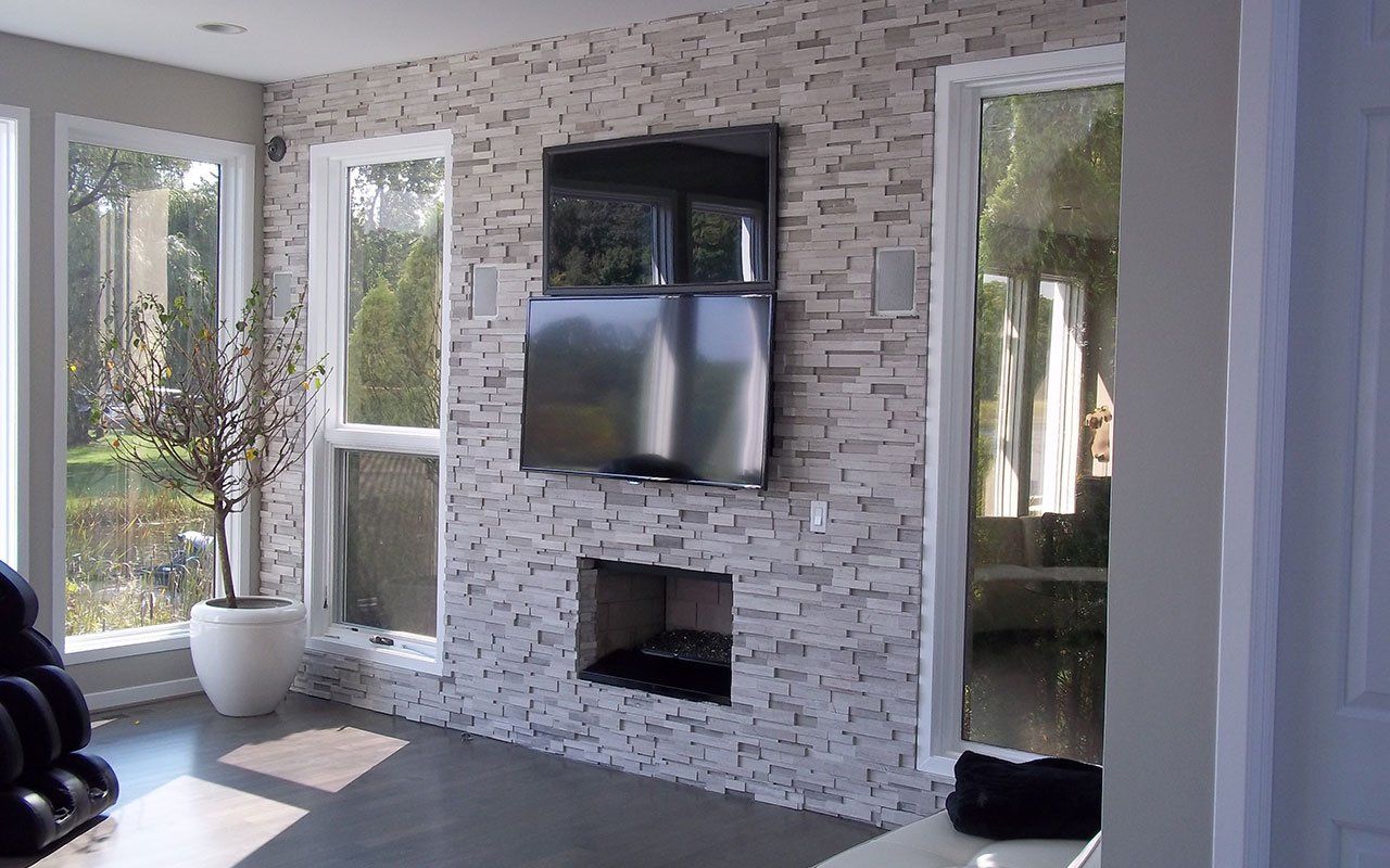 a living room with a fireplace and a flat screen tv on the wall .