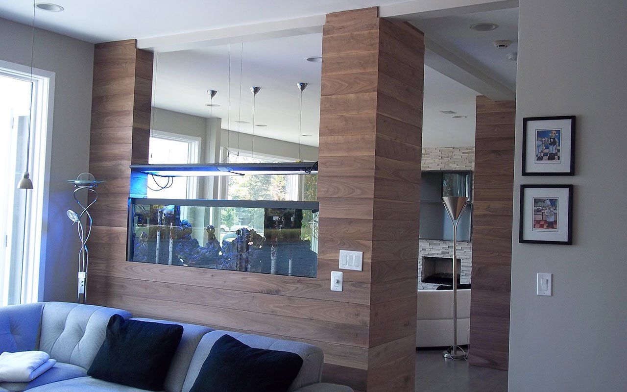 a living room with a couch and a fish tank