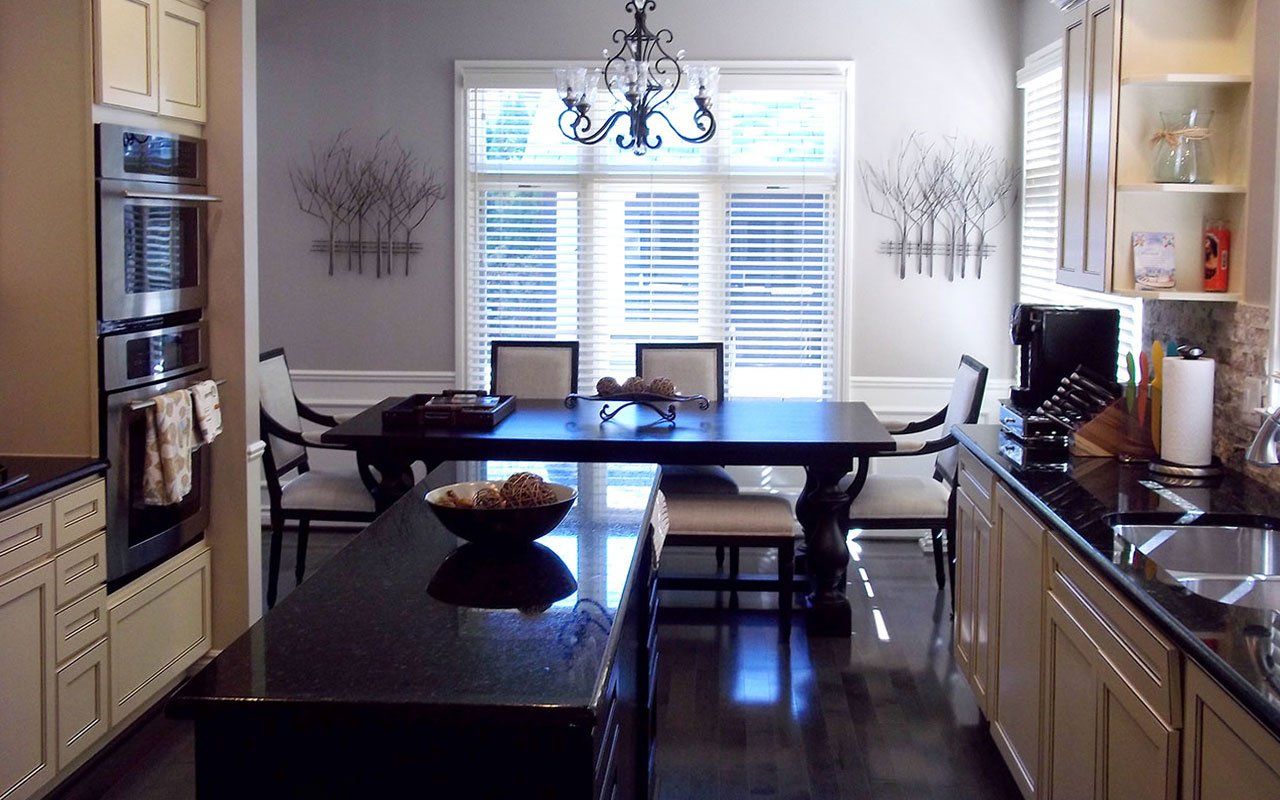 A kitchen with a table and chairs and a sink