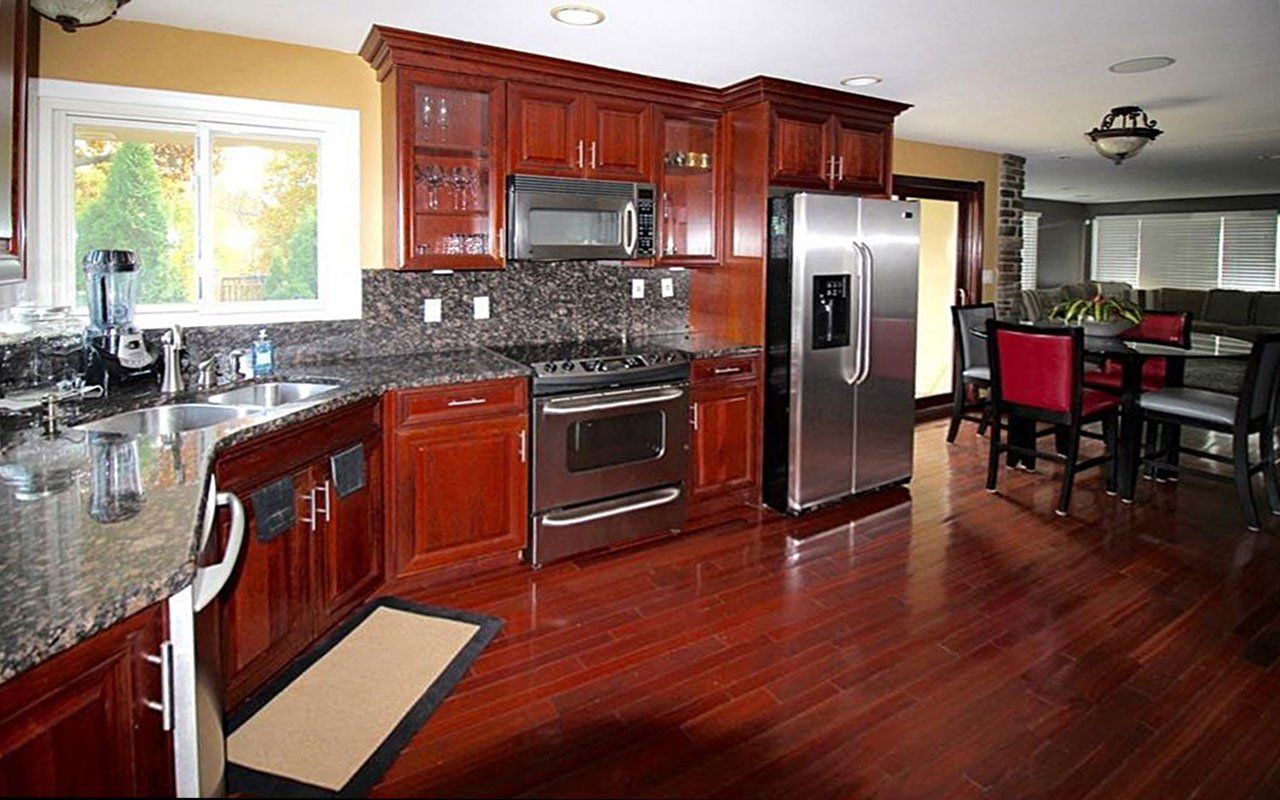 A kitchen with stainless steel appliances and wooden cabinets