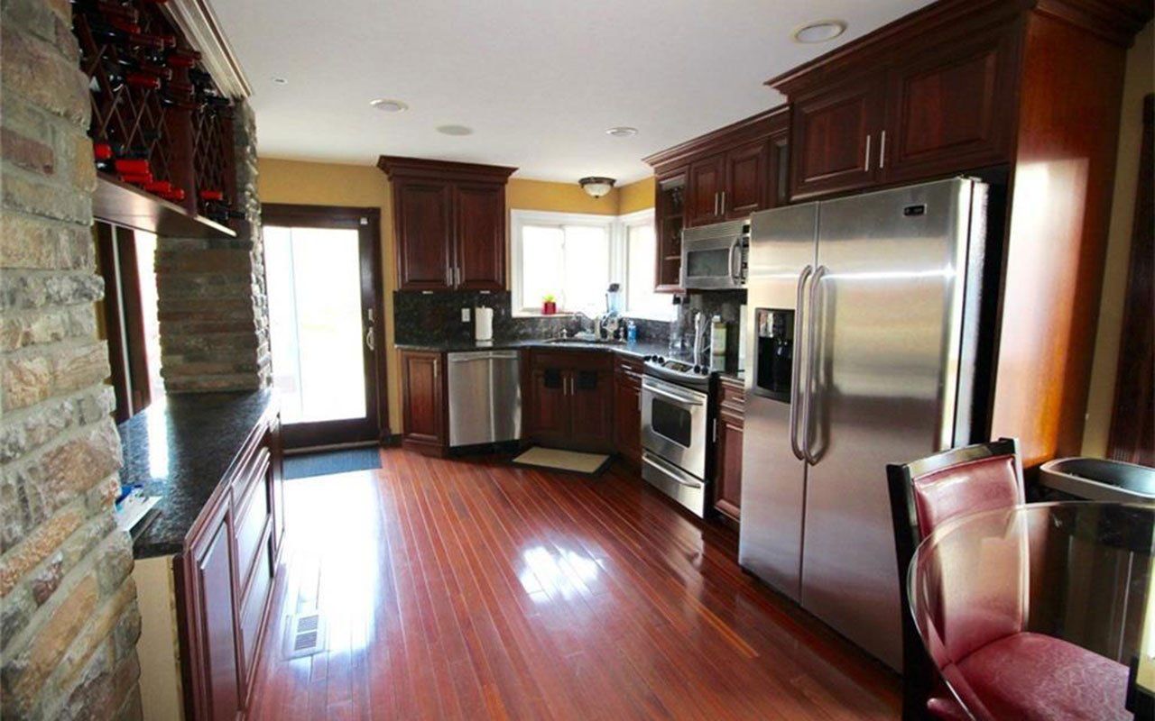 A kitchen with stainless steel appliances and wooden cabinets