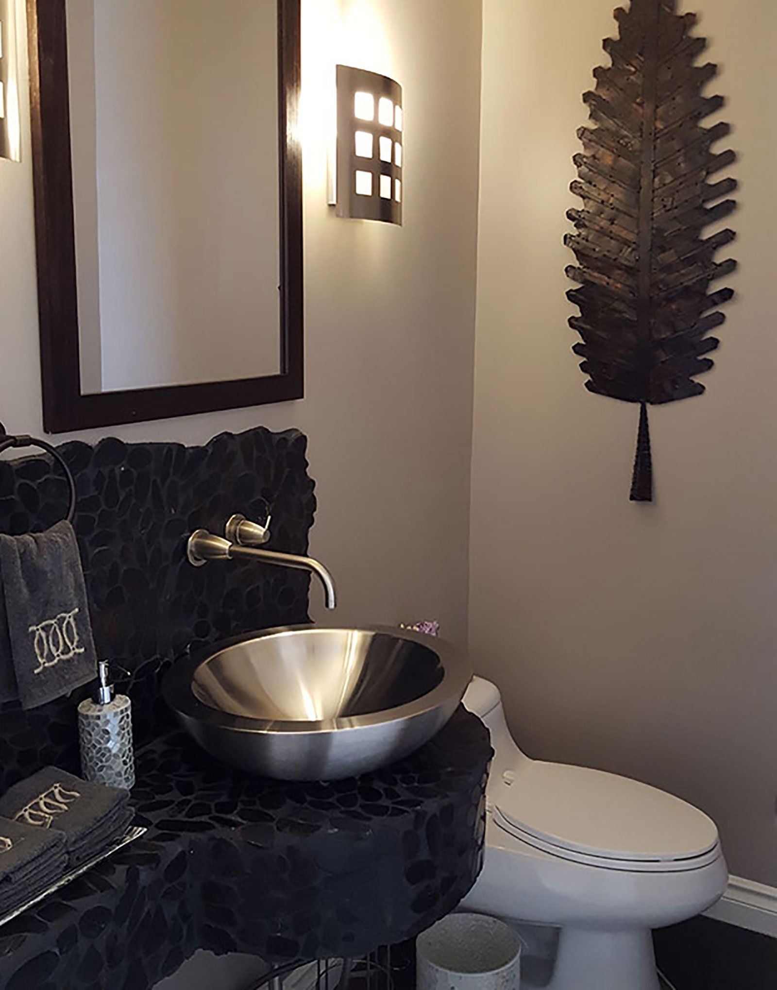 A bathroom with a toilet a sink and a mirror