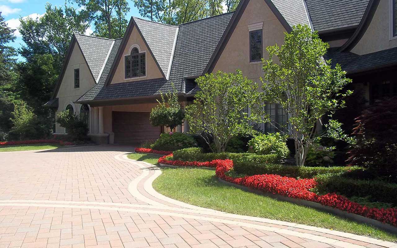 a large house with a brick driveway leading to it