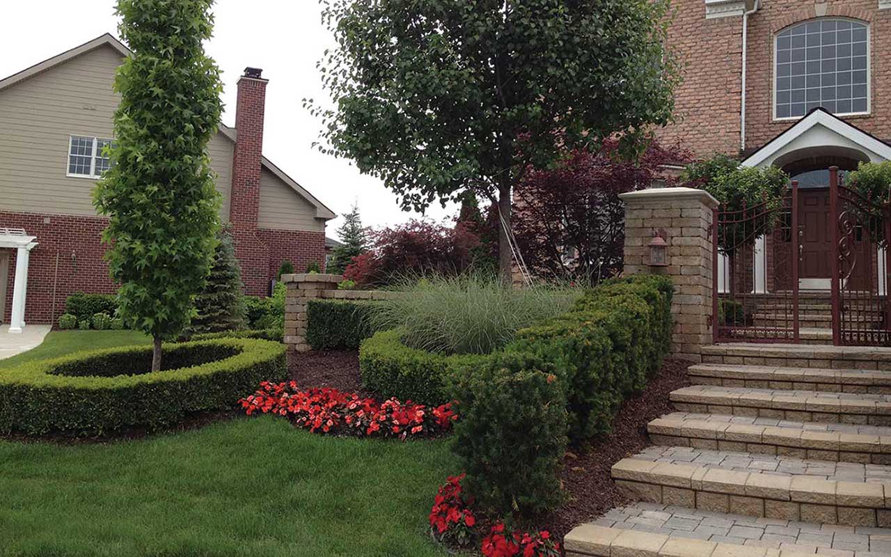 a brick house with stairs leading up to the front door
