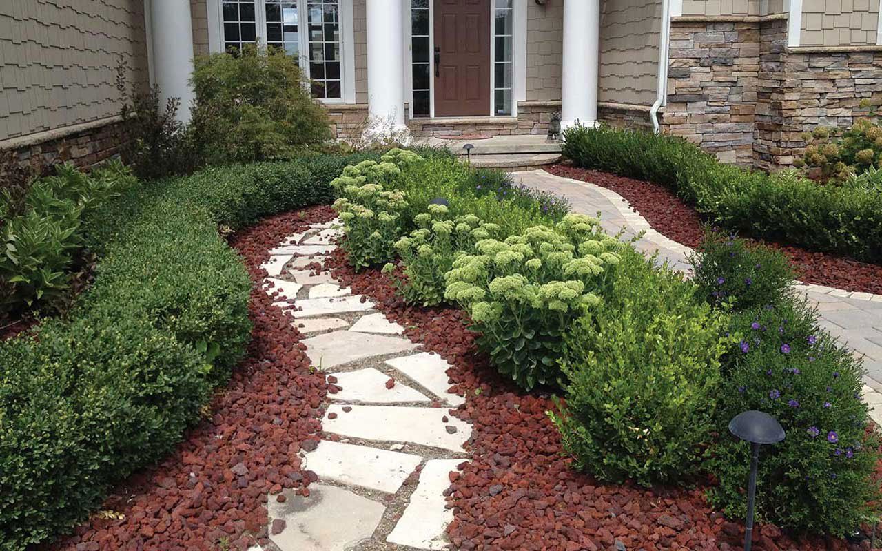 a stone walkway leading to the front door of a house