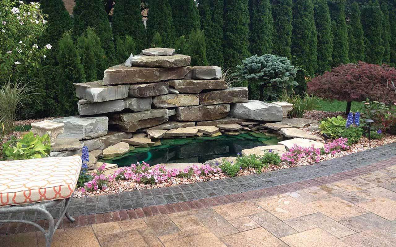 there is a waterfall in the middle of the garden .