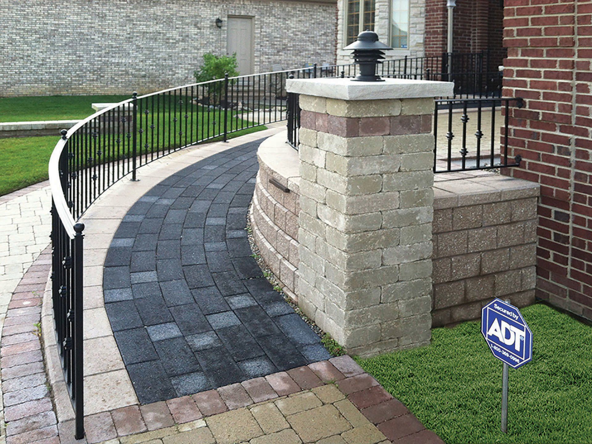 a brick walkway with a sign that says adt on it