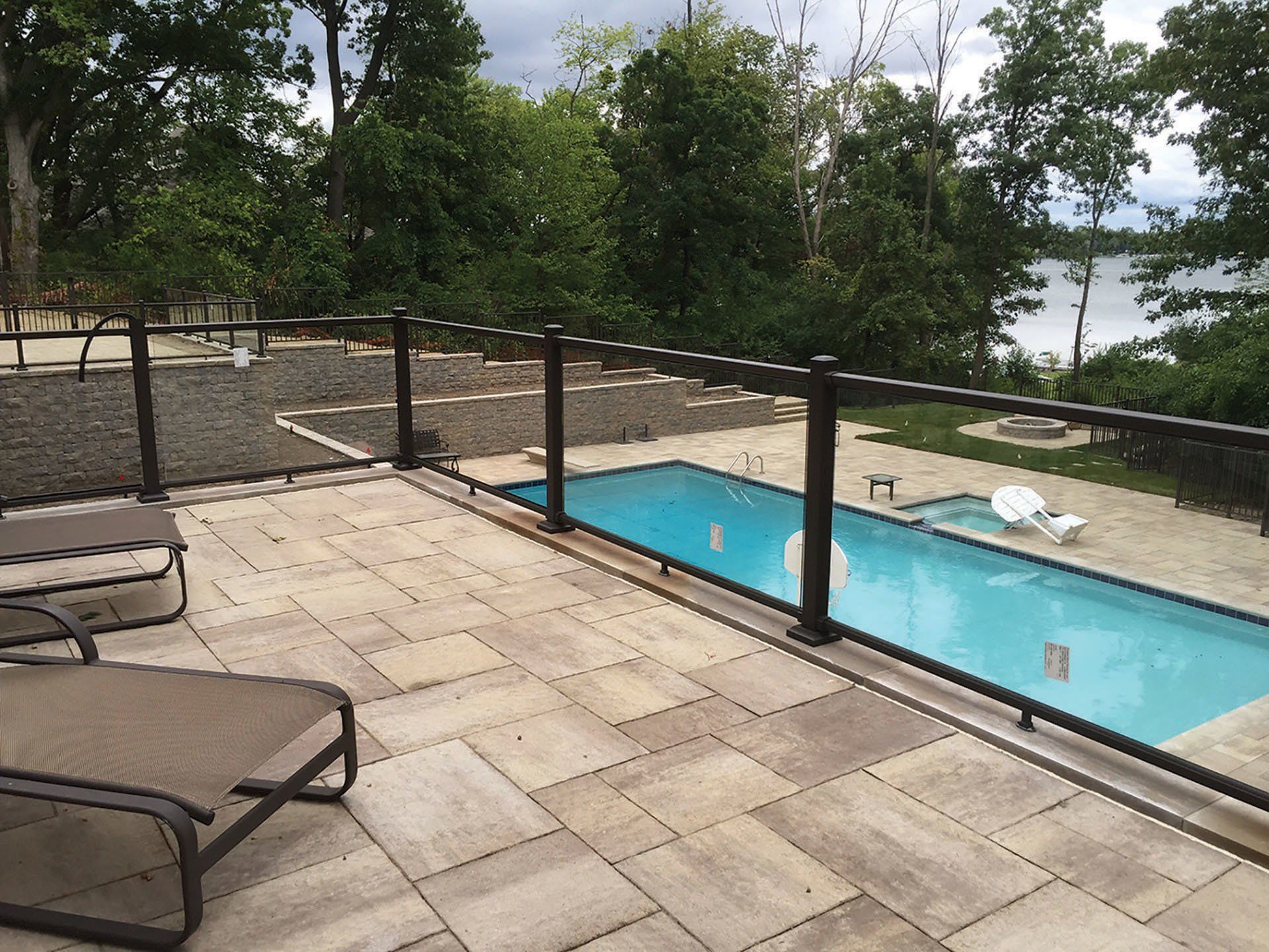 a large swimming pool is surrounded by a glass railing