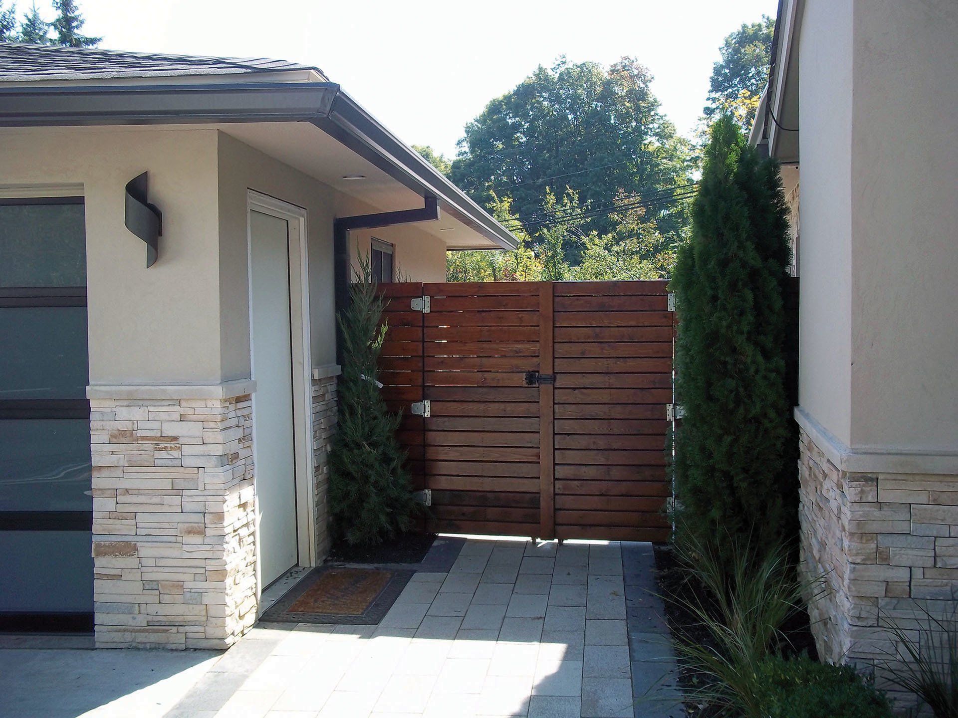 a house with a wooden gate leading to it