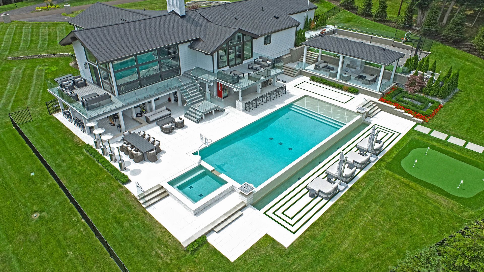 an aerial view of a large house with a swimming pool and a golf course .
