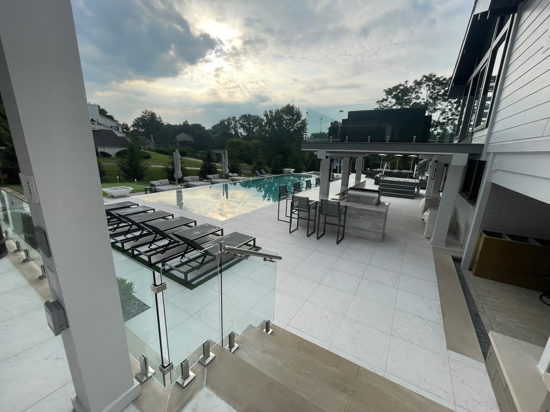 A view of a swimming pool from a balcony of a house.