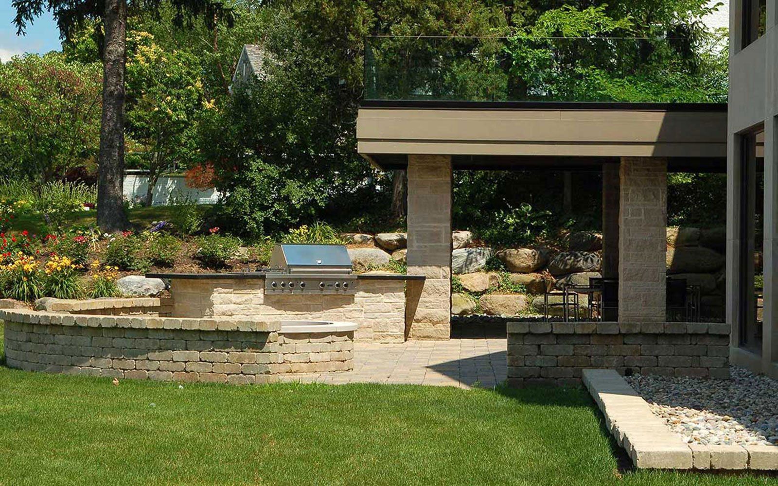 There is a grill in the backyard of a house.