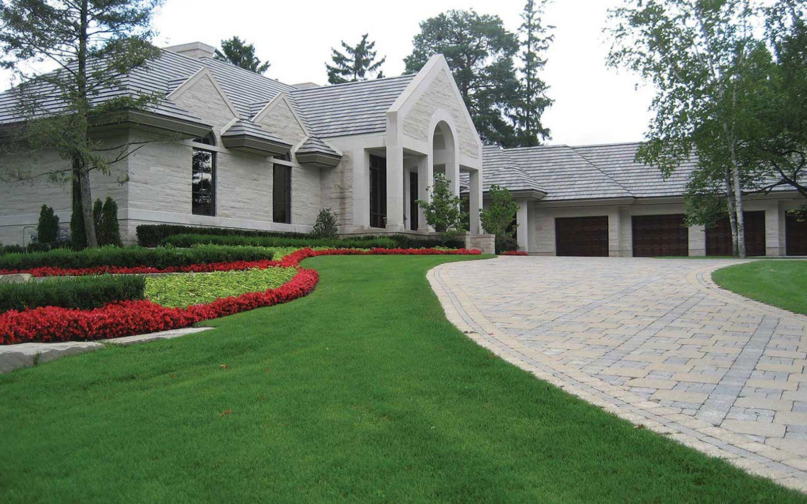 A large white house with a driveway leading to it