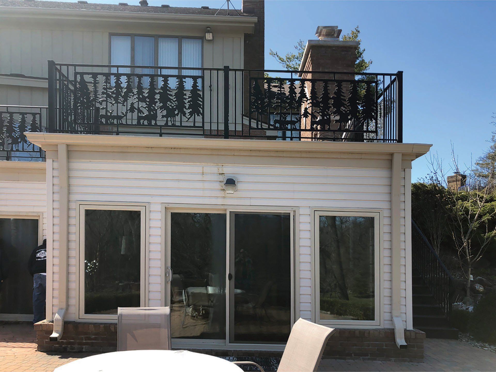 a white house with a balcony on top of it