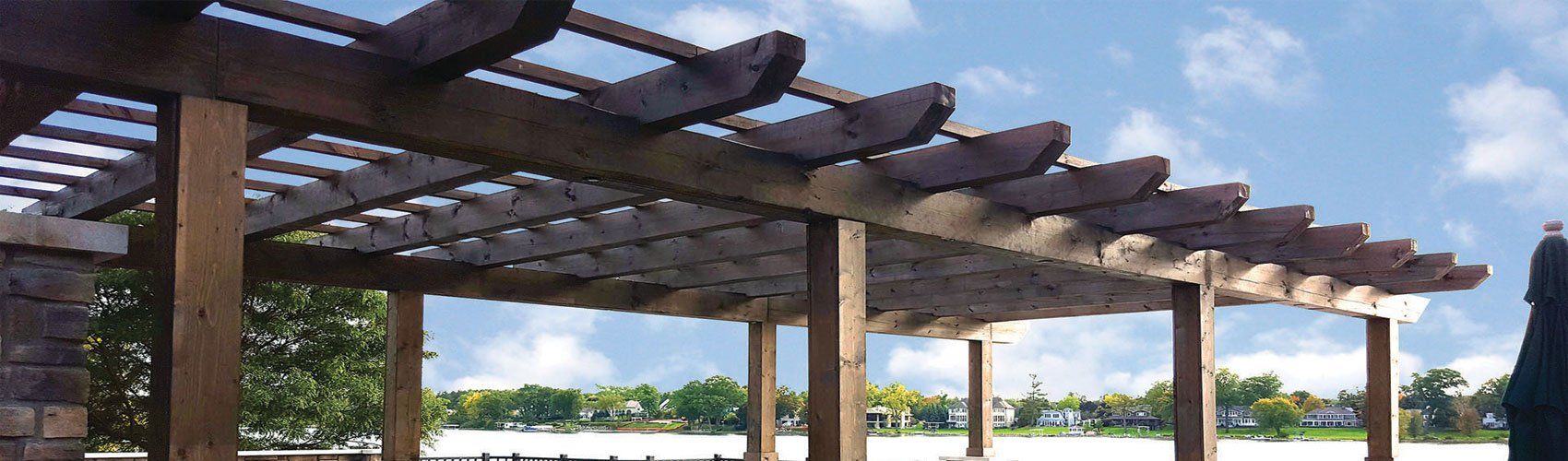 A wooden pergola with a blue sky in the background