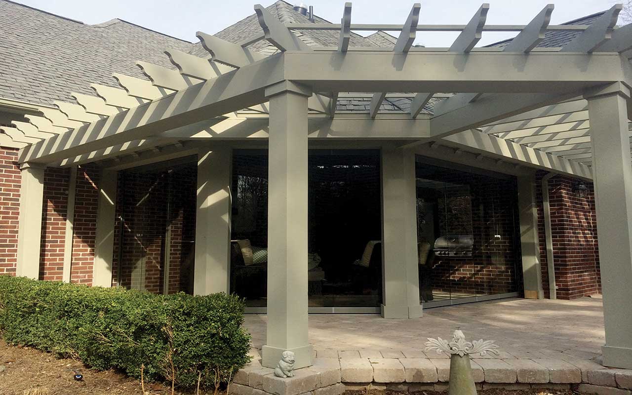 a house with a pergola on the side of it .