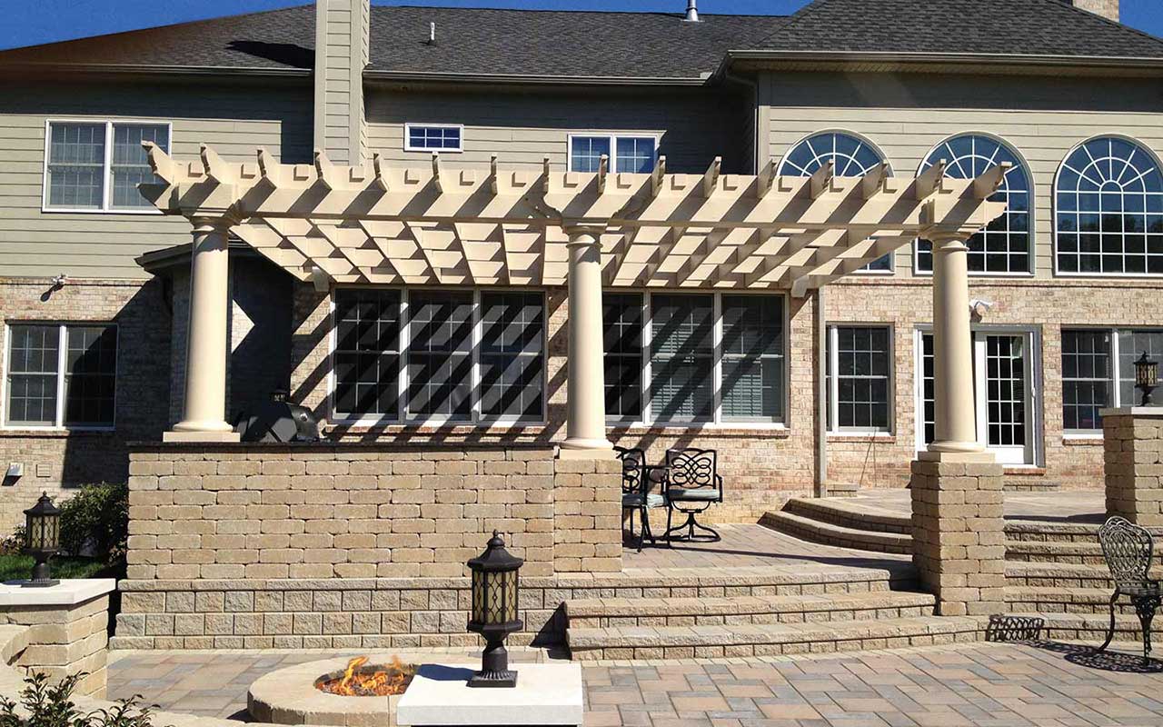 a large house with a pergola in front of it
