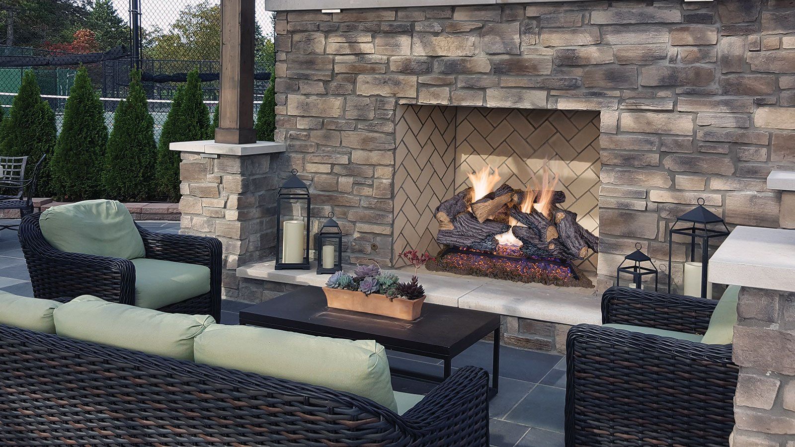 a fireplace with a couch and chairs in front of it