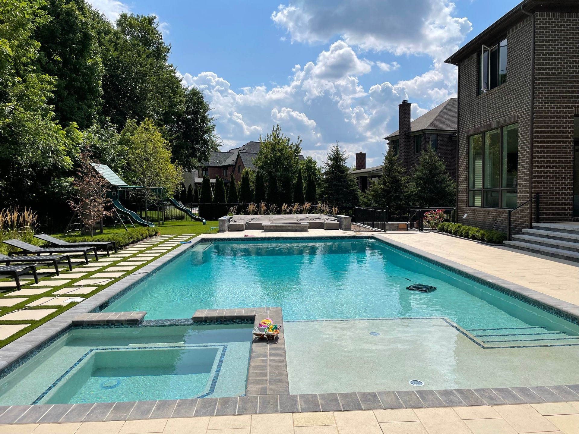 A large swimming pool in the backyard of a house