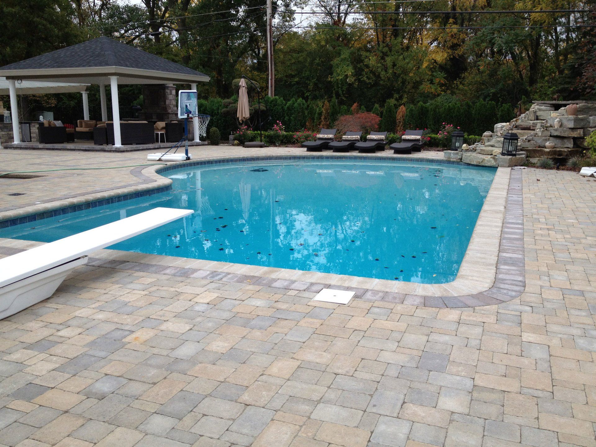 A large swimming pool with a diving board in the middle