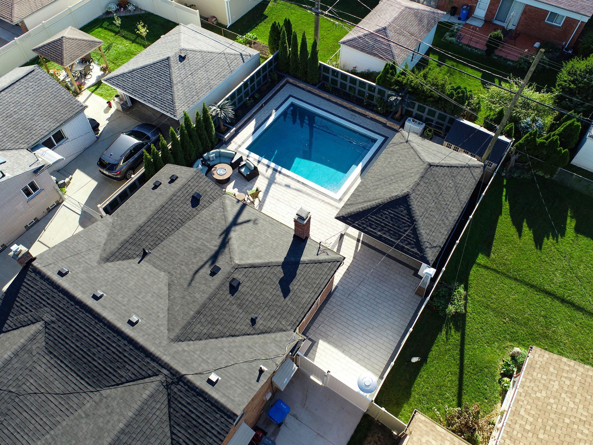 an aerial view of a house with a pool in the backyard