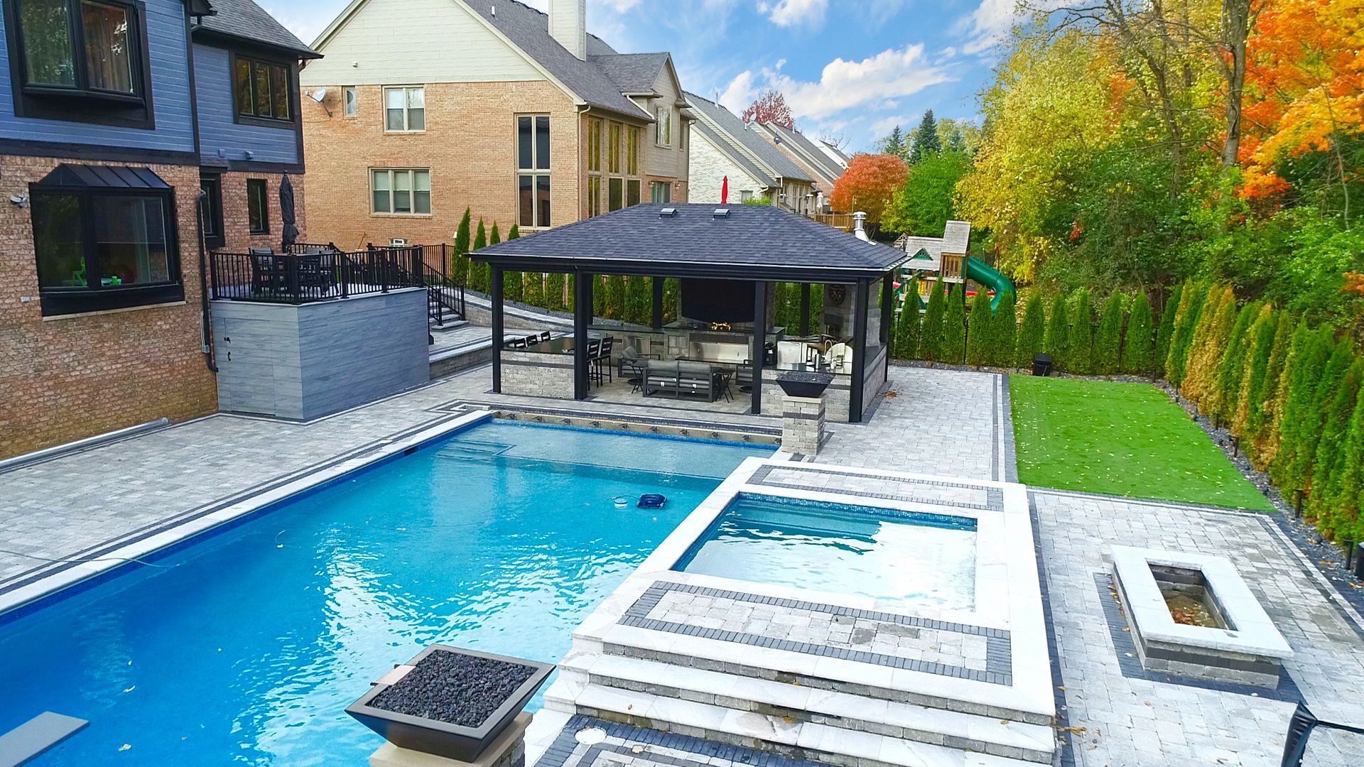 there is a large swimming pool in the backyard of a house .