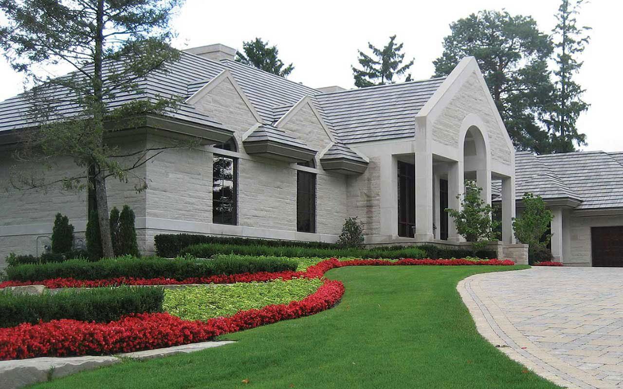 a large white brick house with a gray roof