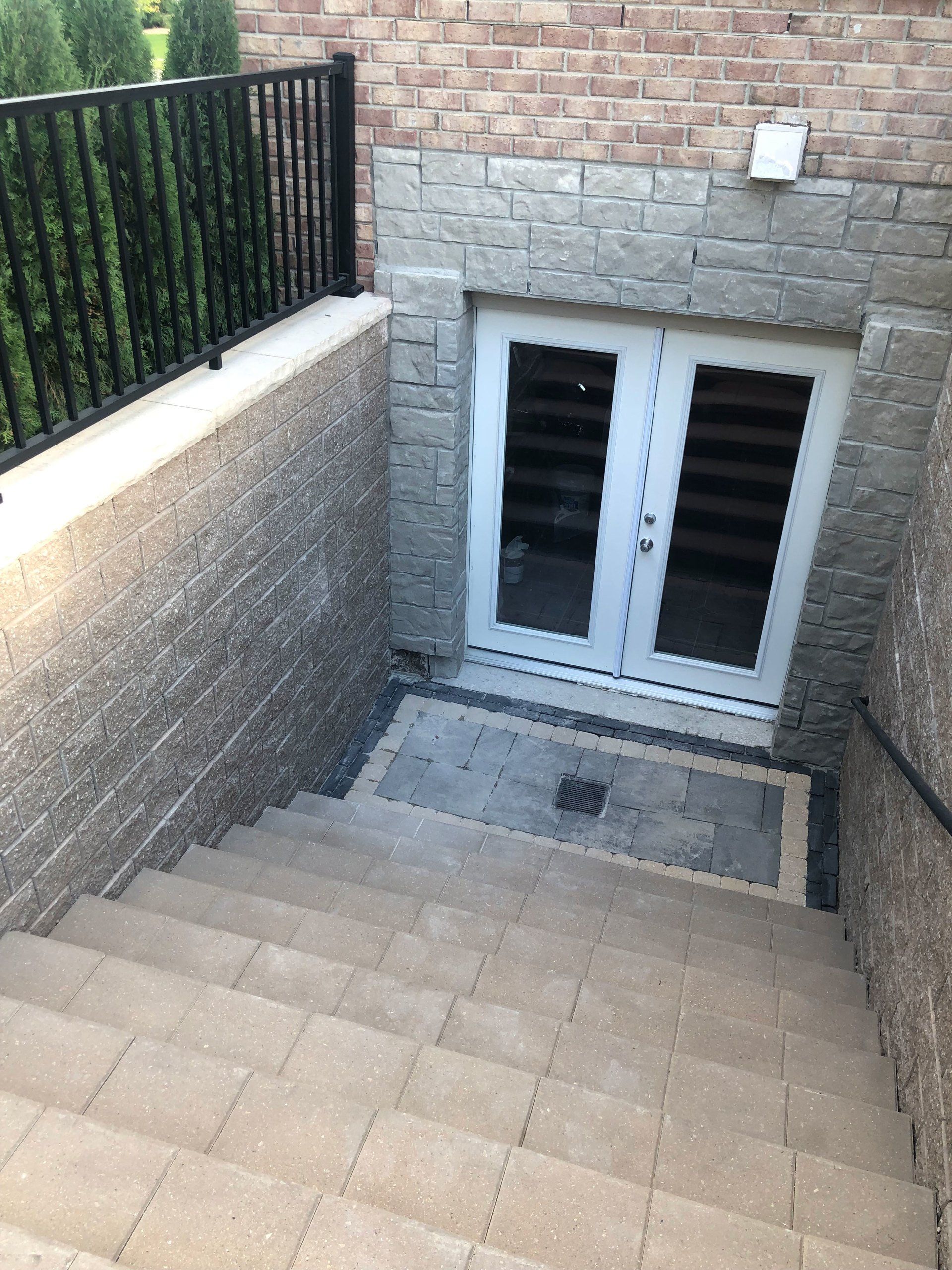 a set of stairs leading down to a basement door .
