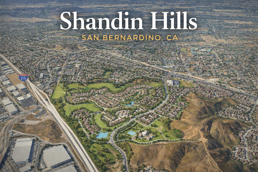 An aerial view of a city with a green area in the middle.