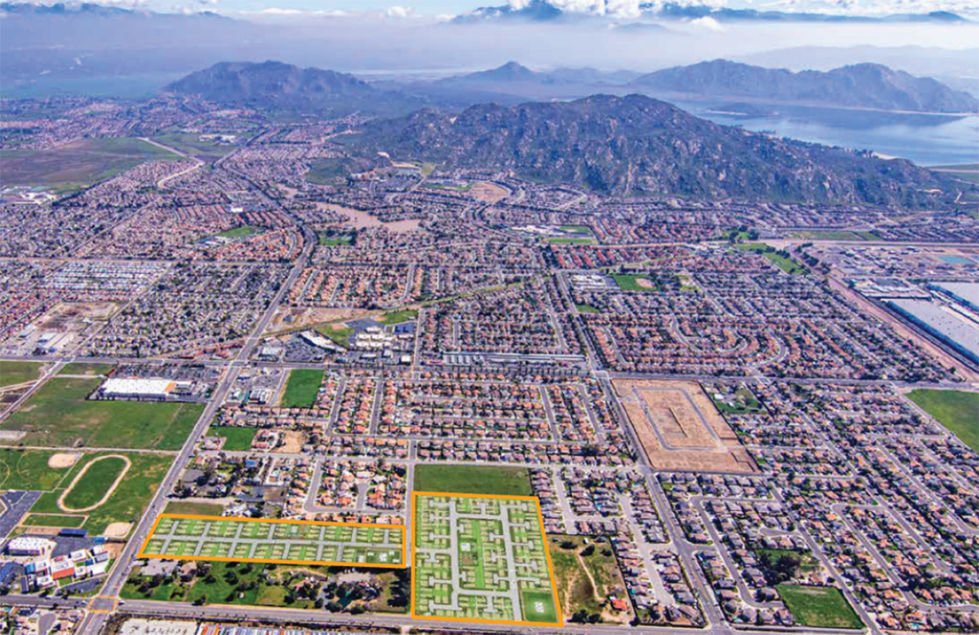 An aerial view of a city with mountains in the background.