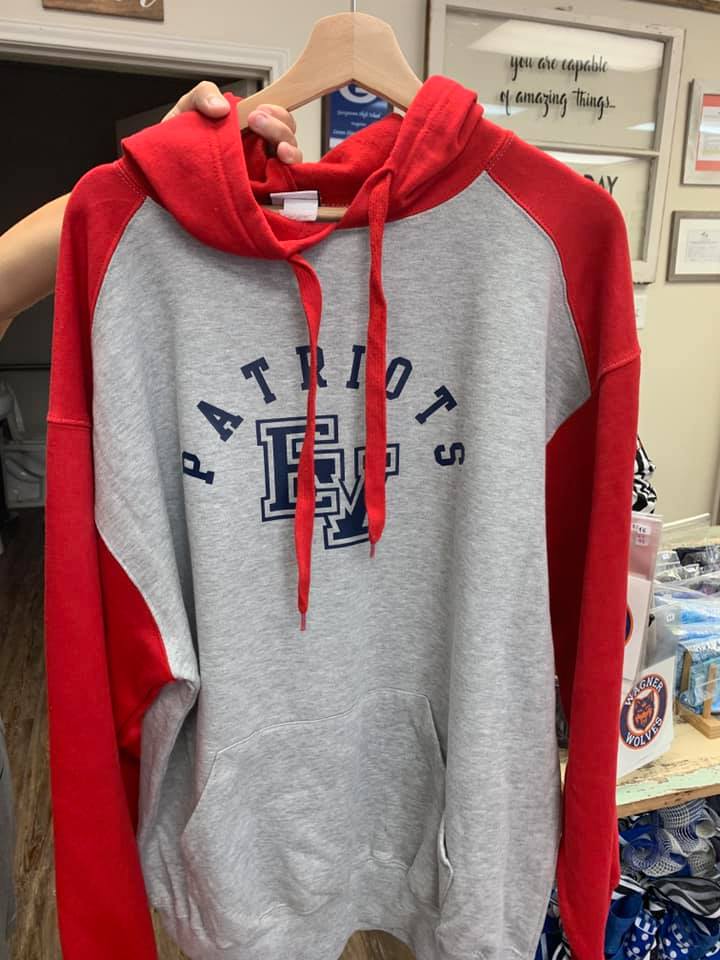 A patriots hoodie is hanging on a hanger.