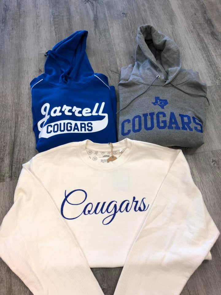 Three sweatshirts with the word cougars on them.