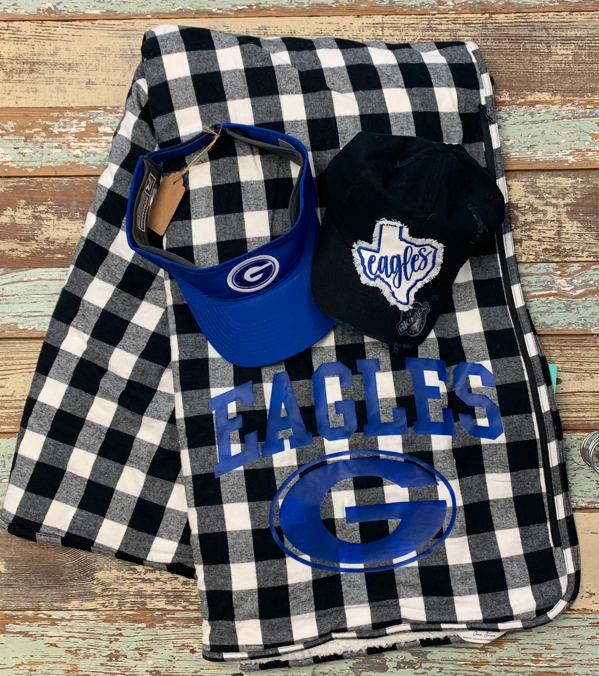 A black and white checkered blanket with the word eagles on it.