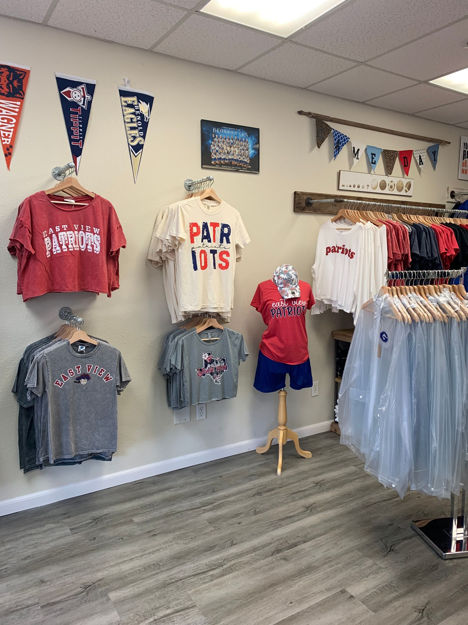 A store filled with lots of shirts hanging on a wall.