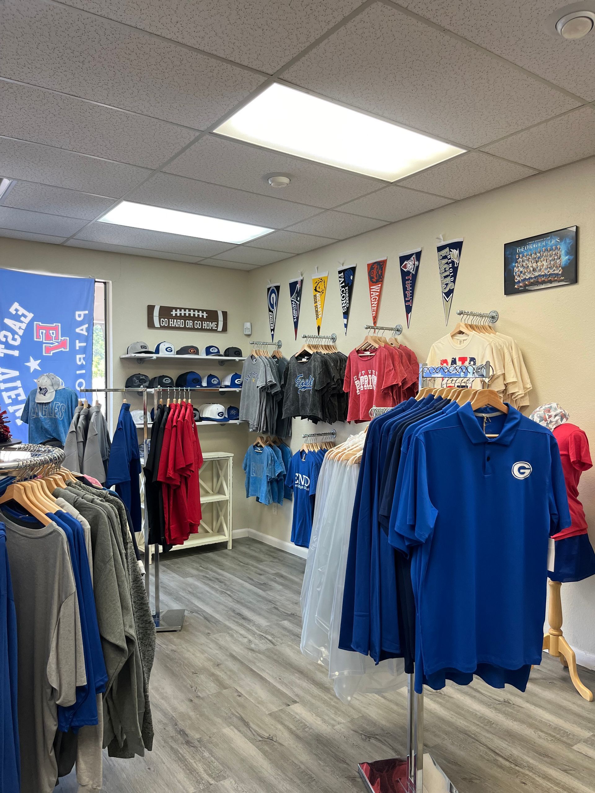 A store filled with lots of blue shirts and hats.