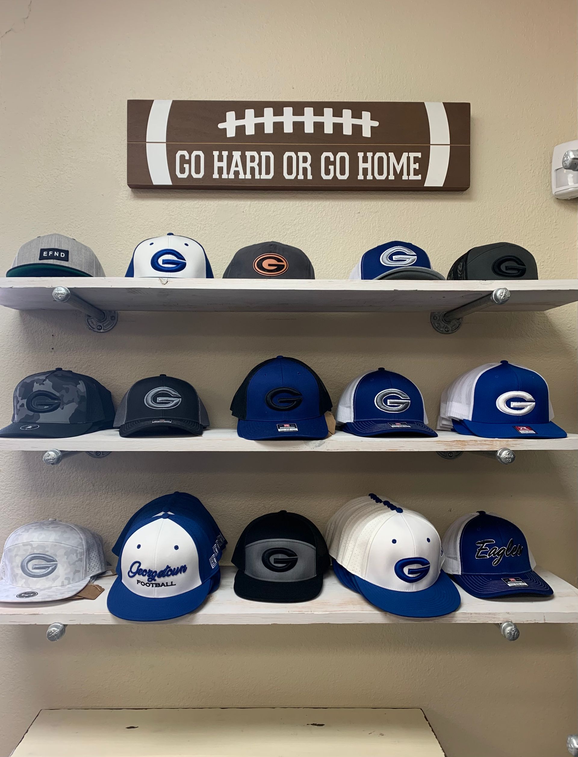 A shelf filled with hats.'