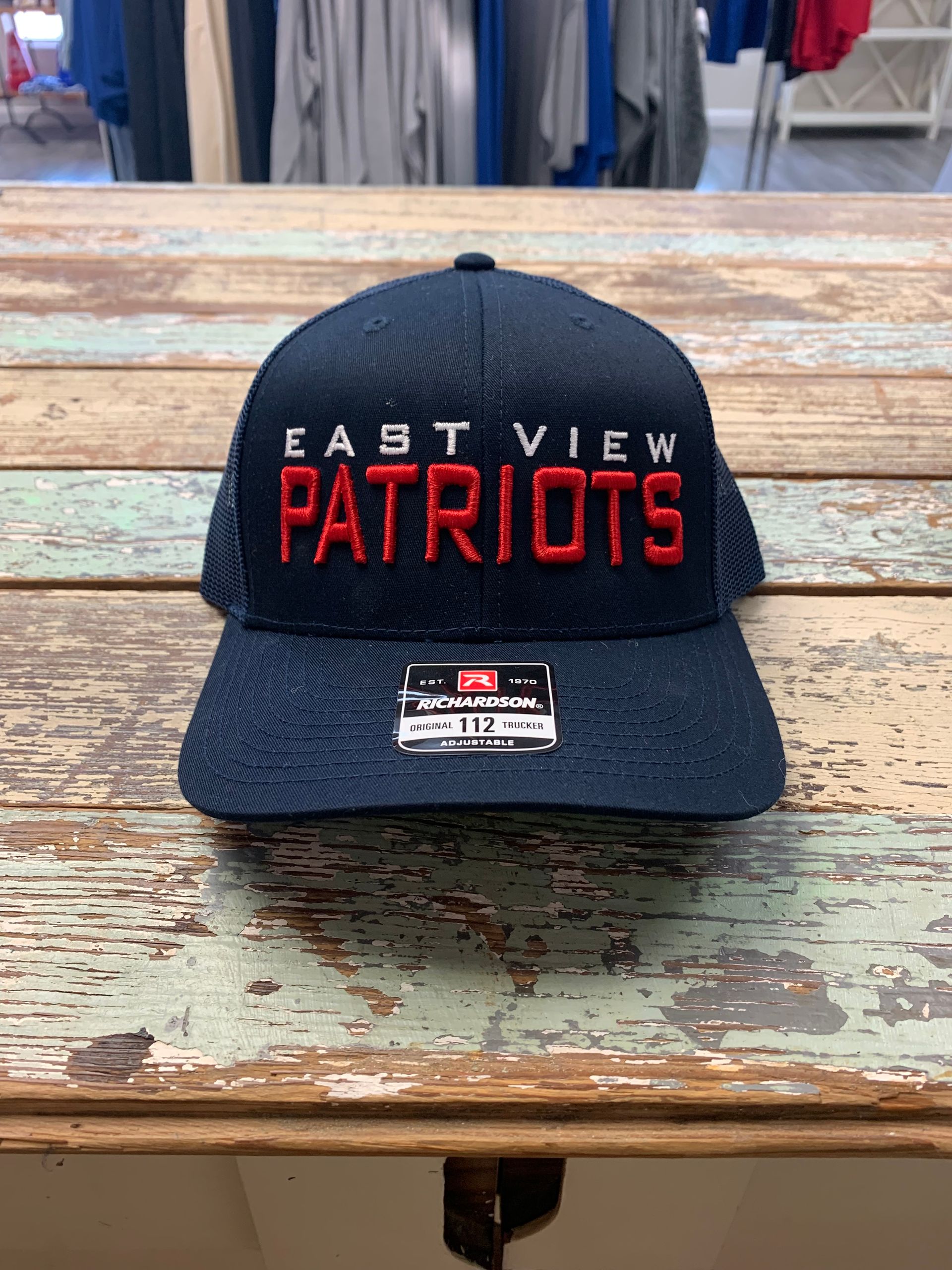 A baseball cap is sitting on top of a wooden table.