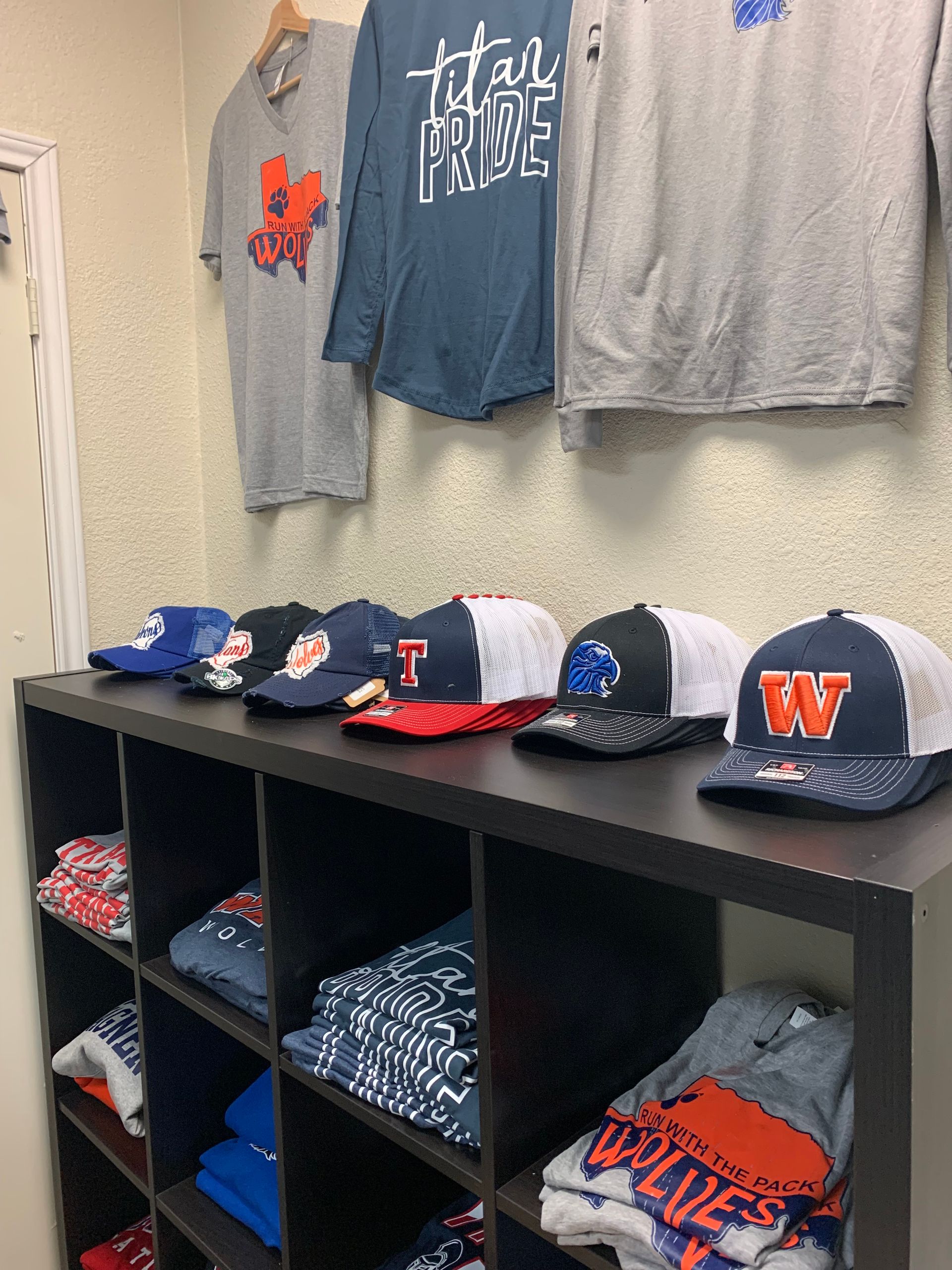 A bunch of hats and shirts.