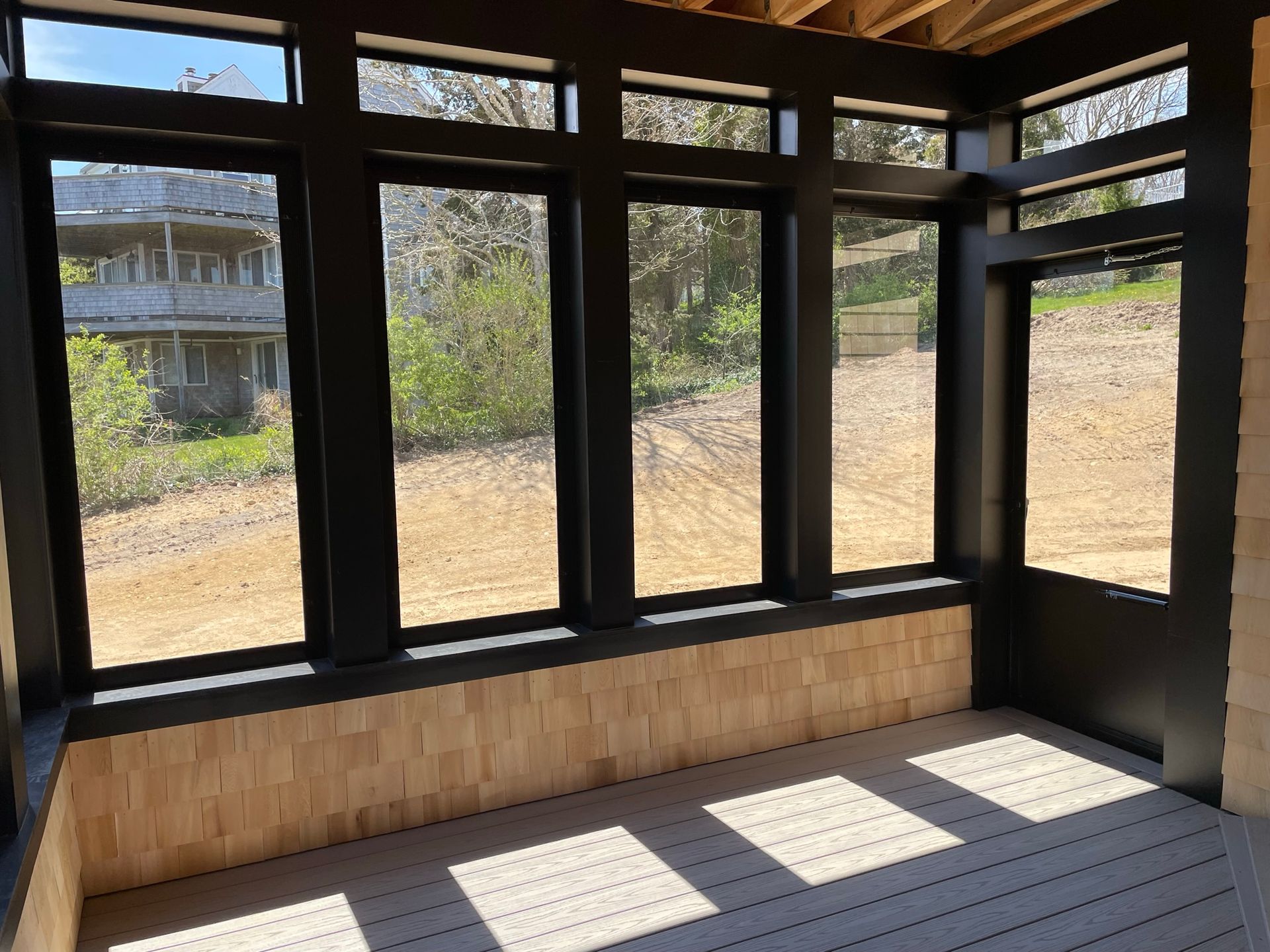 a room with a lot of windows and a wooden floor
